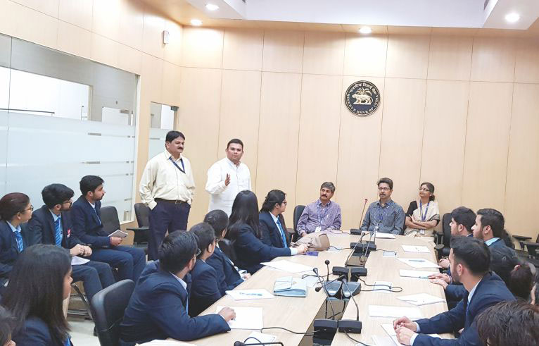 The illustration shows the conference room full of chitkara university students and some business experts.