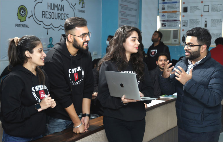 The illustration shows the students of chitkara university. One holds the laptop, others are standing, and the teacher lectures them.