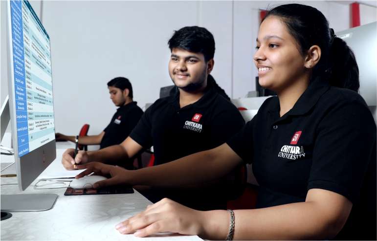 The illustration shows the three students of chitkara university in black T-shirts sitting on a chair. One is holding a mouse and working on a desktop; another is holding a pencil and seeing the desktop.