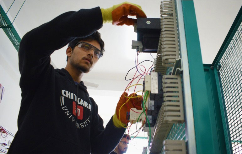 The image shows the student of electric engineering from chitkara university working on their project.