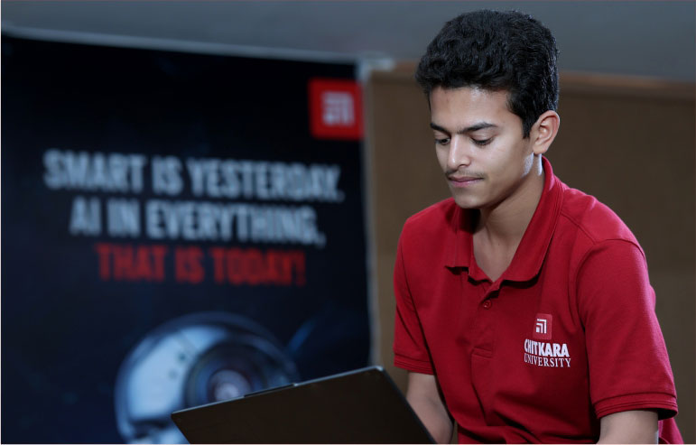 The illustration with a blurred background shiws a boy student of chitkara university working on the laptop.