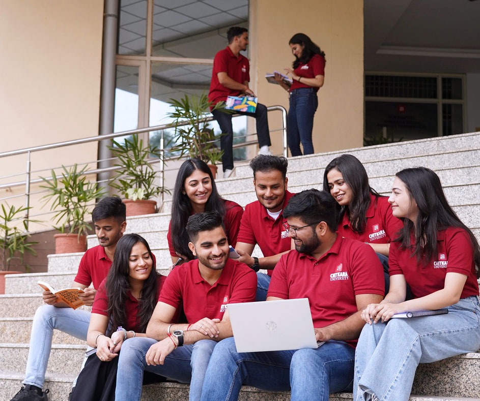 Students collaborating on laptop at Chitkara University for BBA+MBA IPM Integrated Program in Management