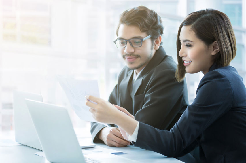 A girl and a student sitting together, looking at a laptop screen, reviewing the Online MBA in Finance program overview from Online ChitkaraU.