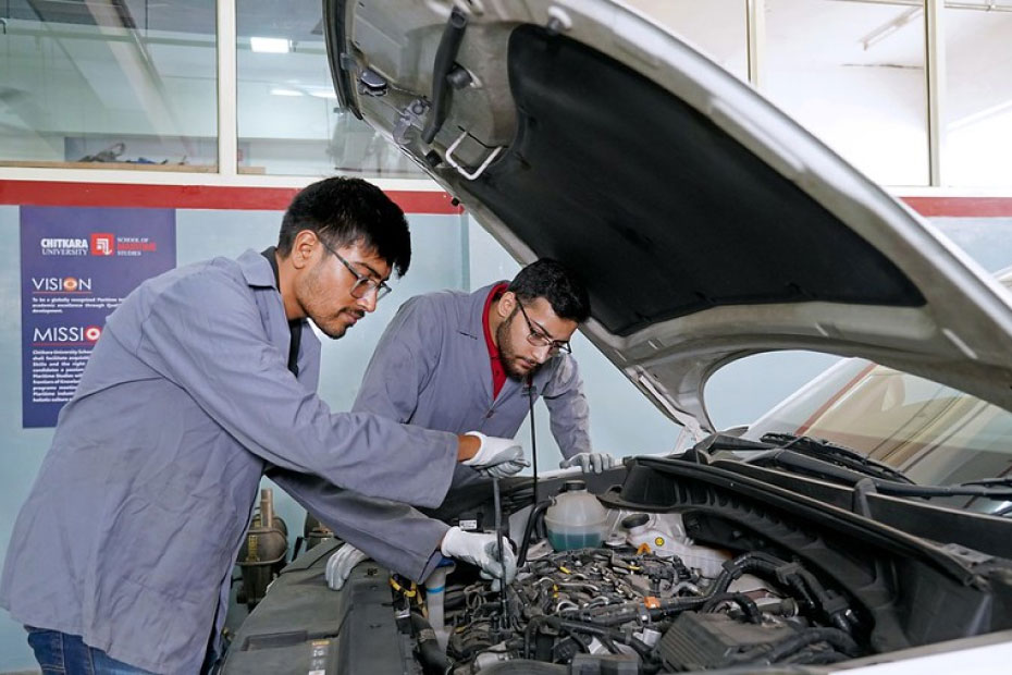 Students working on car engine in B.E. Automobile Engineering at Chitkara University