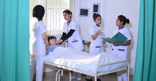 Nursing students practicing bedside patient care during clinical training