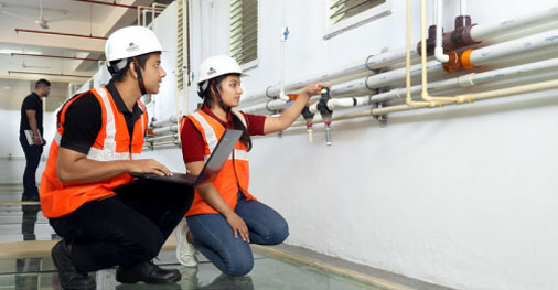 B.E. in Civil Engineering with AI & ML students inspecting industrial piping system