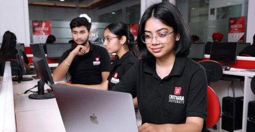 Student working on laptop in 4-Year B.E. in Computer Science & Engineering lab with peers