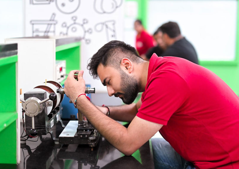 B.E. in Mechatronics Engineering students in lab with sensors and actuators