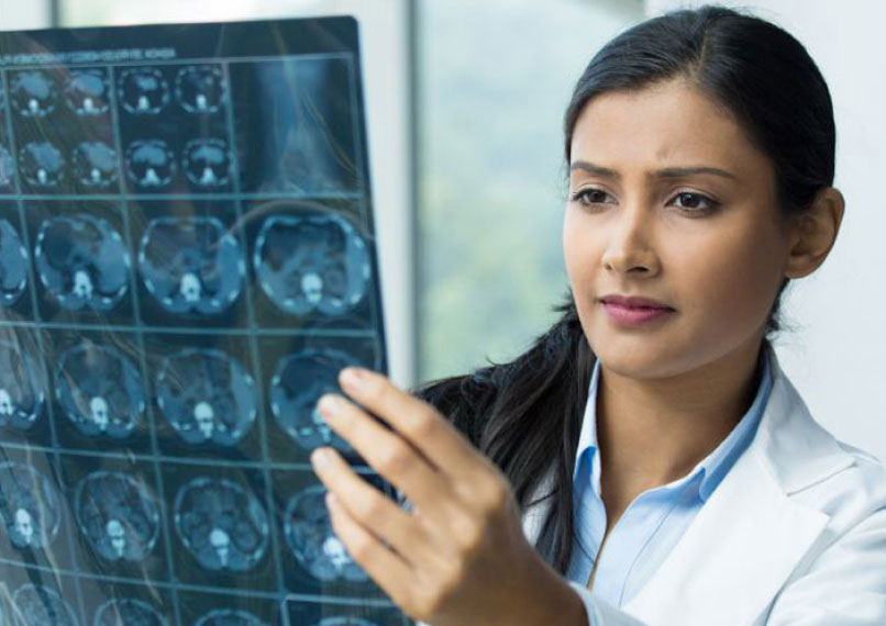 B.Sc in MRIT student examining CT scan images for diagnosis